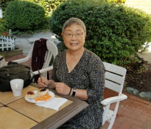 Kathie Shiba eating vegan breakfast at an outdoor table