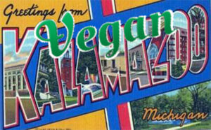 Colorful sign that says Greeting from Vegan Kalamazoo Michigan. Vegan-friendly town.